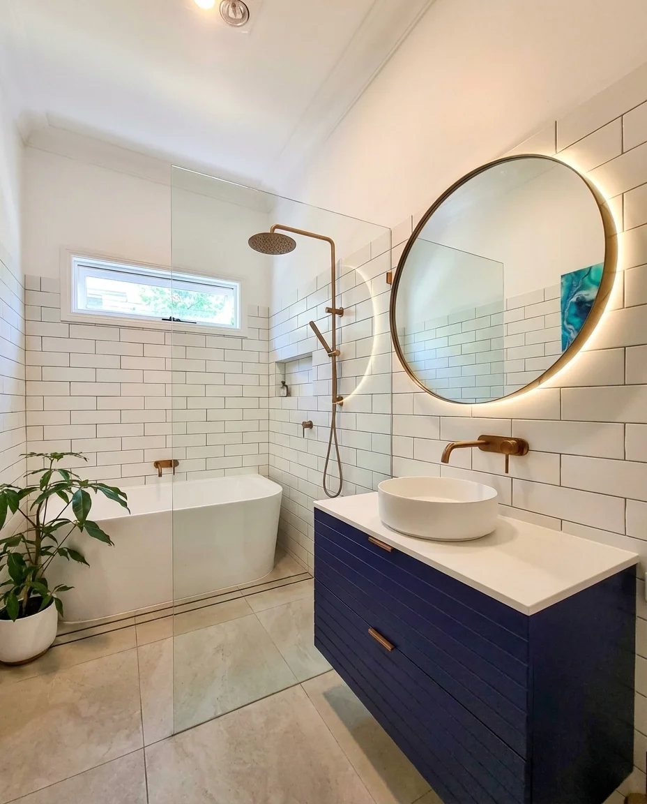 Full bathroom renovation with navy vanity and subway tiles